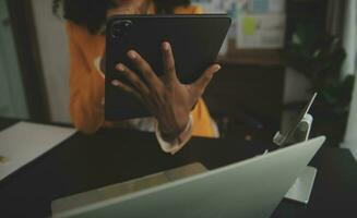 Close up Business woman using calculator and laptop for do math finance on wooden desk, tax, accounting, statistics and analytical research concept photo