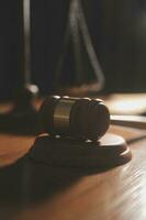 law books and scales of justice on desk in library of law firm. jurisprudence legal education concept. photo