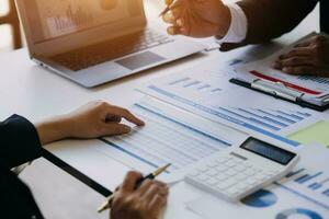 businessman working on desk office with using a calculator to calculate the numbers, finance accounting concept photo