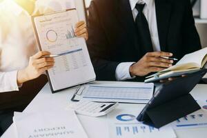 businessman working on desk office with using a calculator to calculate the numbers, finance accounting concept photo