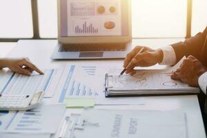 businessman working on desk office with using a calculator to calculate the numbers, finance accounting concept photo