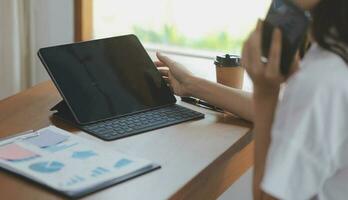 Shot of a asian young business Female working on laptop in her workstation. photo