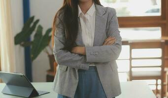 Shot of a asian young business Female working on laptop in her workstation. photo