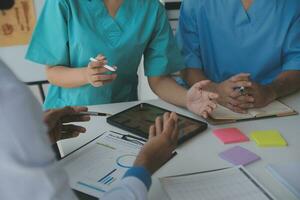 Team of doctors and businesswoman having a meeting in medical office photo