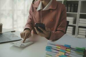 Audit concept,Administrator business man financial inspector and secretary making report calculating balance. Internal Revenue Service checking document. photo