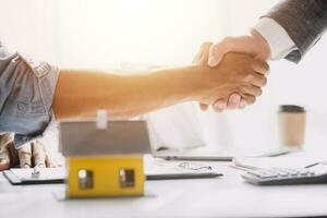 Real estate agent talked about the terms of the home purchase agreement and asked the customer to sign the documents to make the contract legally, Home sales and home insurance concept. photo