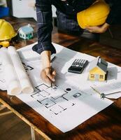 Diverse Team of Specialists Use Tablet Computer on Construction Site. Real Estate Building Project with Civil Engineer, Architect, Business Investor and General Worker Discussing Plan Details. photo