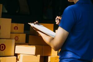 Blue Delivery Men Unloading Package From Truck With Face Mask photo