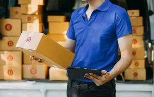 Blue Delivery Men Unloading Package From Truck With Face Mask photo