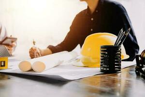 Diverse Team of Specialists Use Tablet Computer on Construction Site. Real Estate Building Project with Civil Engineer, Architect, Business Investor and General Worker Discussing Plan Details. photo