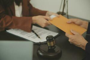 Business and lawyers discussing contract papers with brass scale on desk in office. Law, legal services, advice, justice and law concept picture with film grain effect photo