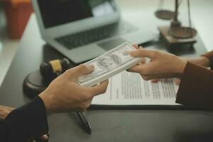 Business and lawyers discussing contract papers with brass scale on desk in office. Law, legal services, advice, justice and law concept picture with film grain effect photo