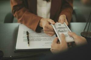 Business and lawyers discussing contract papers with brass scale on desk in office. Law, legal services, advice, justice and law concept picture with film grain effect photo