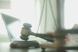Business and lawyers discussing contract papers with brass scale on desk in office. Law, legal services, advice, justice and law concept picture with film grain effect photo