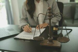 Business and lawyers discussing contract papers with brass scale on desk in office. Law, legal services, advice, justice and law concept picture with film grain effect photo