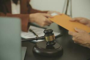 Business and lawyers discussing contract papers with brass scale on desk in office. Law, legal services, advice, justice and law concept picture with film grain effect photo