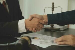 Business and lawyers discussing contract papers with brass scale on desk in office. Law, legal services, advice, justice and law concept picture with film grain effect photo