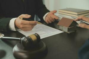 Business and lawyers discussing contract papers with brass scale on desk in office. Law, legal services, advice, justice and law concept picture with film grain effect photo