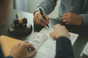 Business and lawyers discussing contract papers with brass scale on desk in office. Law, legal services, advice, justice and law concept picture with film grain effect photo