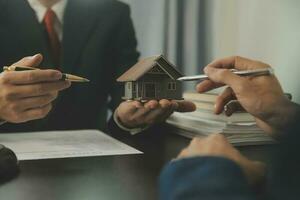 Business and lawyers discussing contract papers with brass scale on desk in office. Law, legal services, advice, justice and law concept picture with film grain effect photo