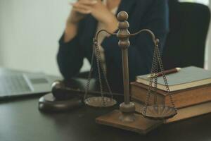 Justice and law concept.Male judge in a courtroom with the gavel, working with, computer and docking keyboard, eyeglasses, on table in morning light photo