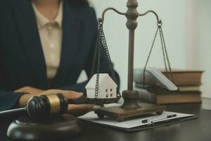 Justice and law concept.Male judge in a courtroom with the gavel, working with, computer and docking keyboard, eyeglasses, on table in morning light photo