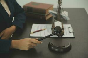 Justice and law concept.Male judge in a courtroom with the gavel, working with, computer and docking keyboard, eyeglasses, on table in morning light photo