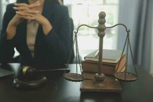 Justice and law concept.Male judge in a courtroom with the gavel, working with, computer and docking keyboard, eyeglasses, on table in morning light photo