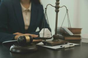 Justice and law concept.Male judge in a courtroom with the gavel, working with, computer and docking keyboard, eyeglasses, on table in morning light photo