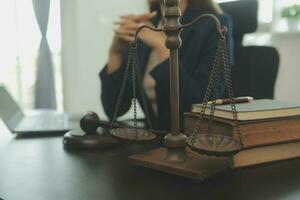 Justice and law concept.Male judge in a courtroom with the gavel, working with, computer and docking keyboard, eyeglasses, on table in morning light photo