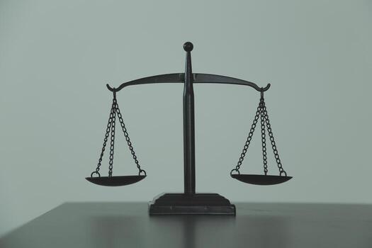 Justice and law concept.Male judge in a courtroom with the gavel, working with, computer and docking keyboard, eyeglasses, on table in morning light photo