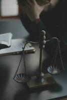 Justice and law concept.Male judge in a courtroom with the gavel, working with, computer and docking keyboard, eyeglasses, on table in morning light photo