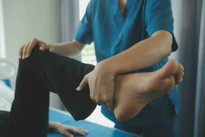 Physiotherapist working with patient in clinic, closeup photo