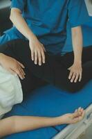 Physiotherapist working with patient in clinic, closeup photo