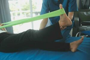 Physiotherapist working with patient in clinic, closeup photo