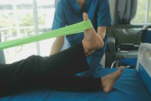 Physiotherapist working with patient in clinic, closeup photo