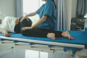 Physiotherapist working with patient in clinic, closeup photo