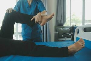 Physiotherapist working with patient in clinic, closeup photo