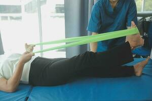 Physiotherapist working with patient in clinic, closeup photo