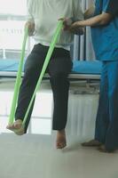 Physiotherapist working with patient in clinic, closeup photo