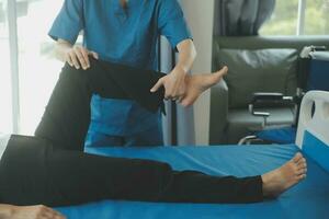 Physiotherapist working with patient in clinic, closeup photo