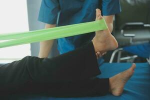 Physiotherapist working with patient in clinic, closeup photo