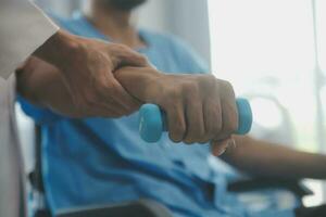 Physical therapist guiding patient with resistance band photo