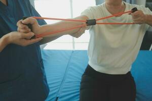 Patient doing some special exercises under supervision in a room photo