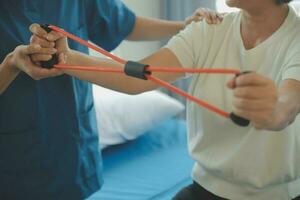 Patient doing some special exercises under supervision in a room photo