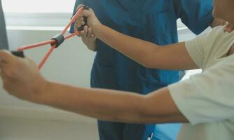 Patient doing some special exercises under supervision in a room photo