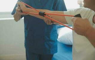 Patient doing some special exercises under supervision in a room photo