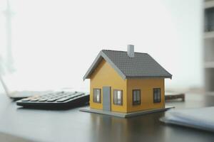 Female woman hands holding home model, small miniature white toy house. Mortgage property insurance dream moving home and real estate concept photo