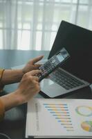 Audit concept,Administrator business man financial inspector and secretary making report calculating balance. Internal Revenue Service checking document. photo