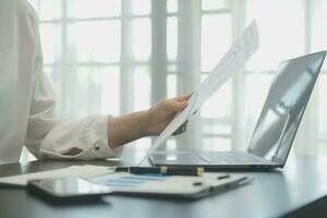Audit concept,Administrator business man financial inspector and secretary making report calculating balance. Internal Revenue Service checking document. photo